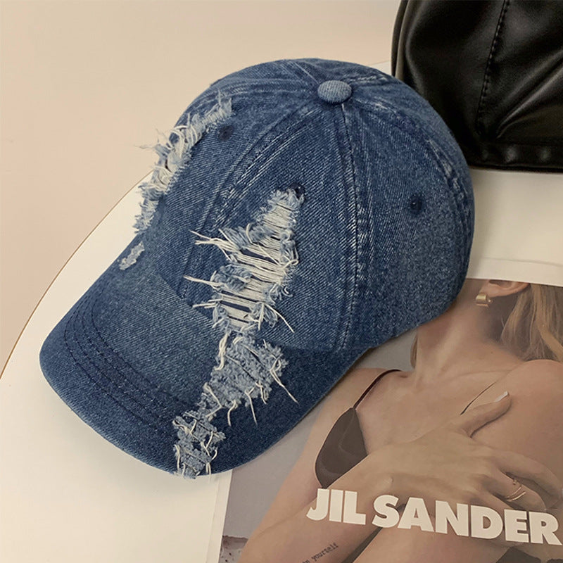 Dark blue denim baseball cap with frayed distressed front patch