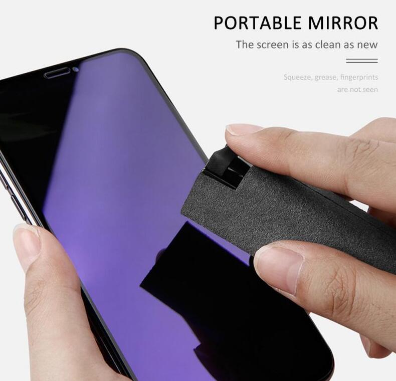 Portable mirror style screen cleaner bottle with gray microfiber cloth on a phone screen