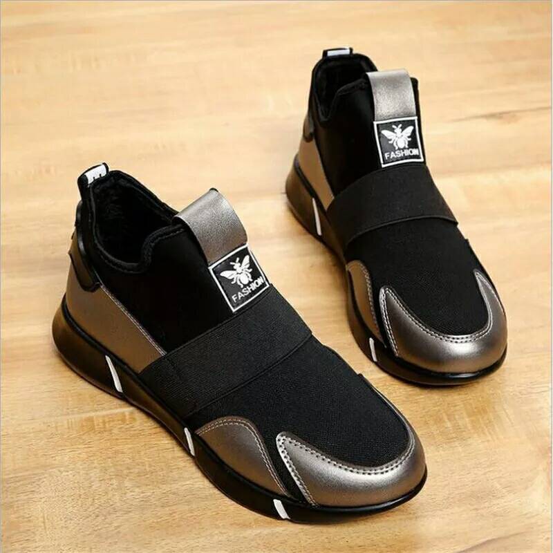 Black and dark-brown slip-on shoes with metallic toe panels and white logo tag