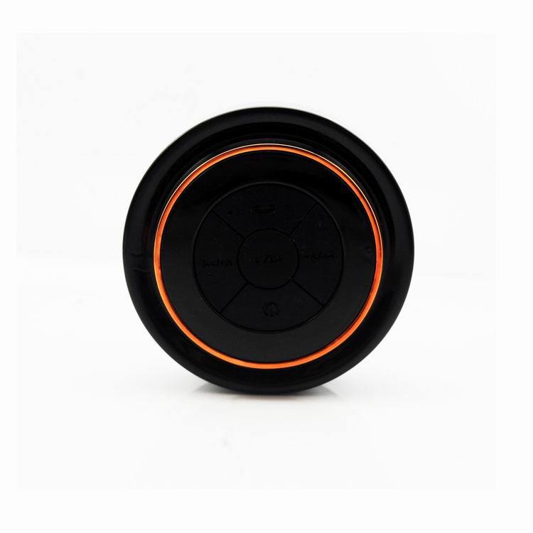 Bluetooth waterproof speaker front with orange LED ring and circular control panel
