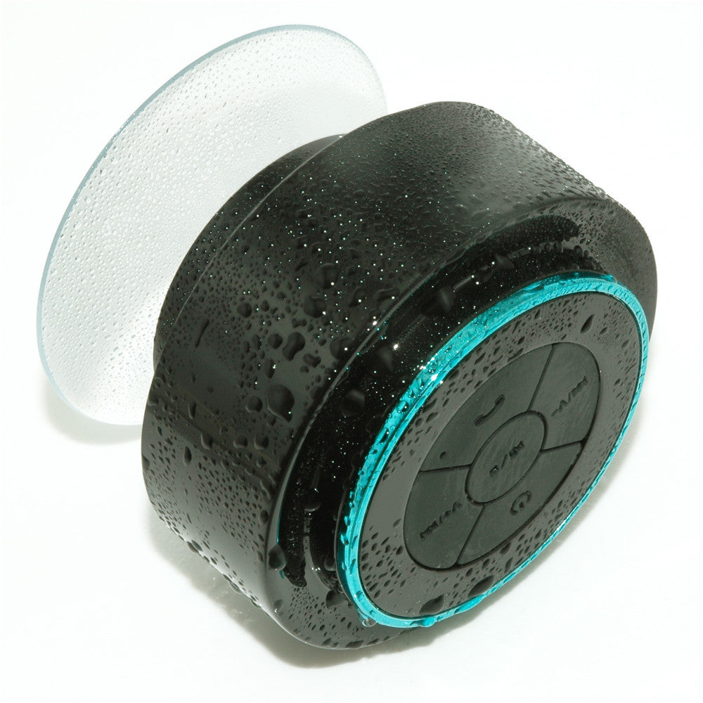 Portable Bluetooth speaker, black body with teal LED ring and circular control panel