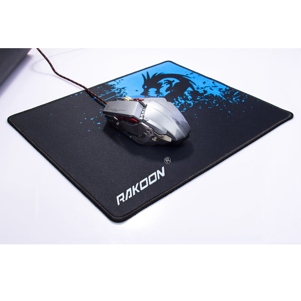 Mouse pad with black surface and blue dragon graphic, RAKOON logo under a gaming mouse