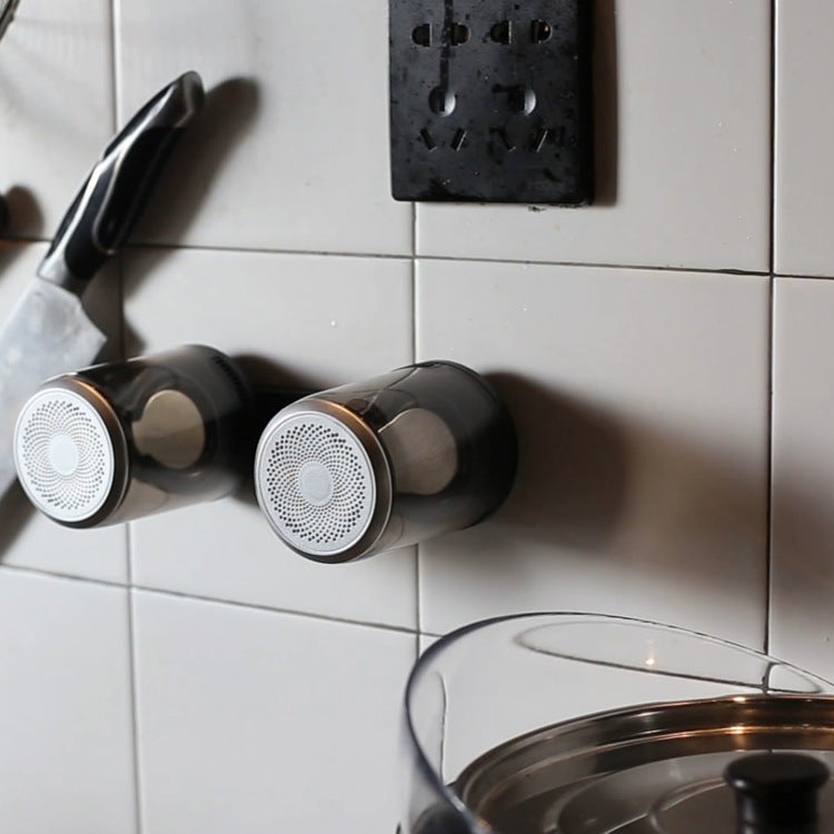 Bluetooth speaker pair mounted on wall tiles with circular grilles and transparent bodies