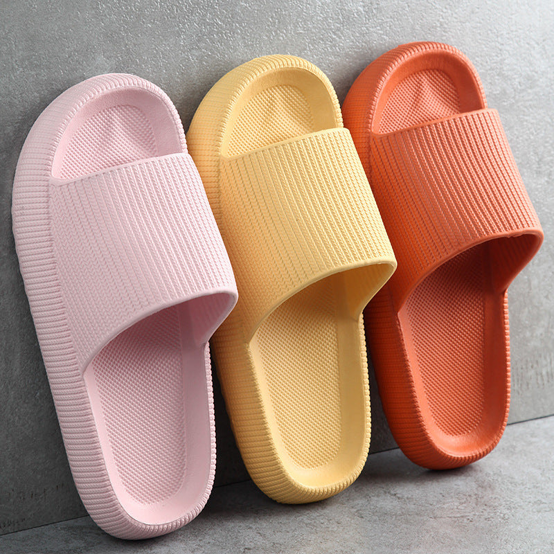 Pink, yellow, and orange slide slippers with textured straps and cushioned soles