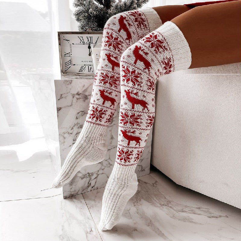 Over-the-knee knit socks in red with white reindeer and snowflake pattern