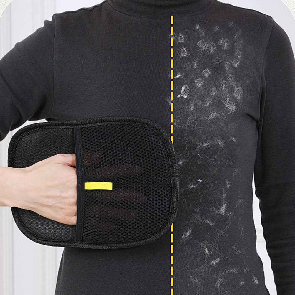 Black pet hair removal mitt with textured surface and yellow tab, held by person