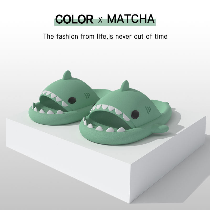 Cartoon shark slippers, green slide-on sandals with white teeth and fin details