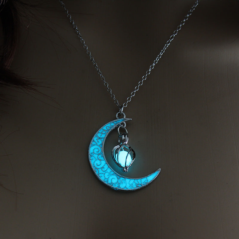 Silver chain pendant with glowing blue moon charm and cat lantern detail