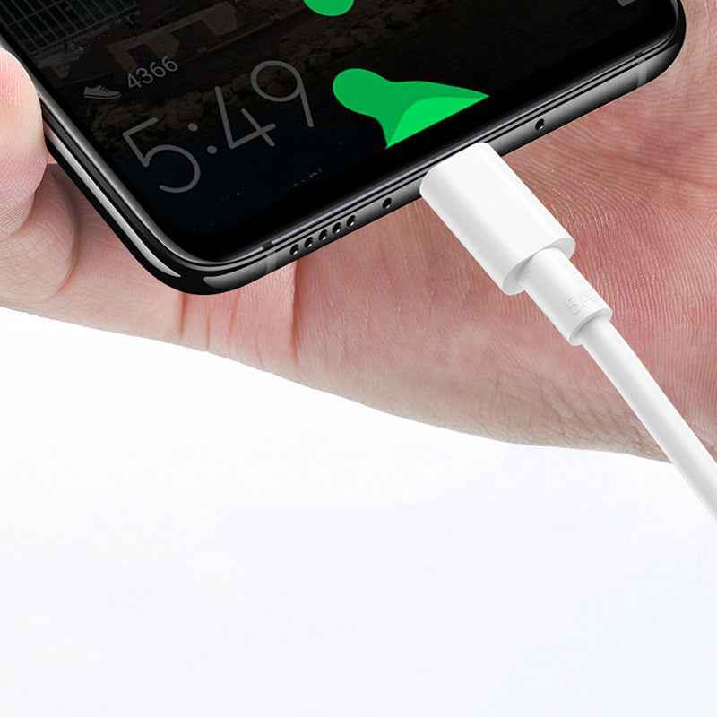 White USB-C charging cable plugged into smartphone charging port
