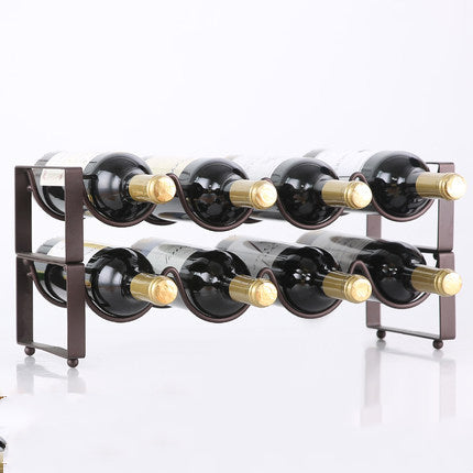 Two-tier black metal wine bottle rack with eight curved slots, holding eight bottles