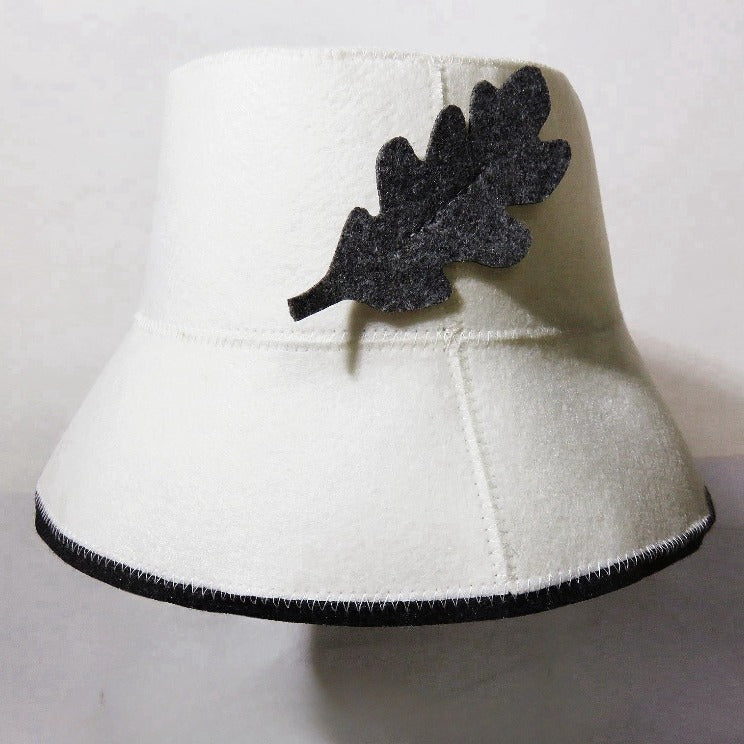 White wool fisherman bucket hat with dark leaf felt applique and stitched brim trim