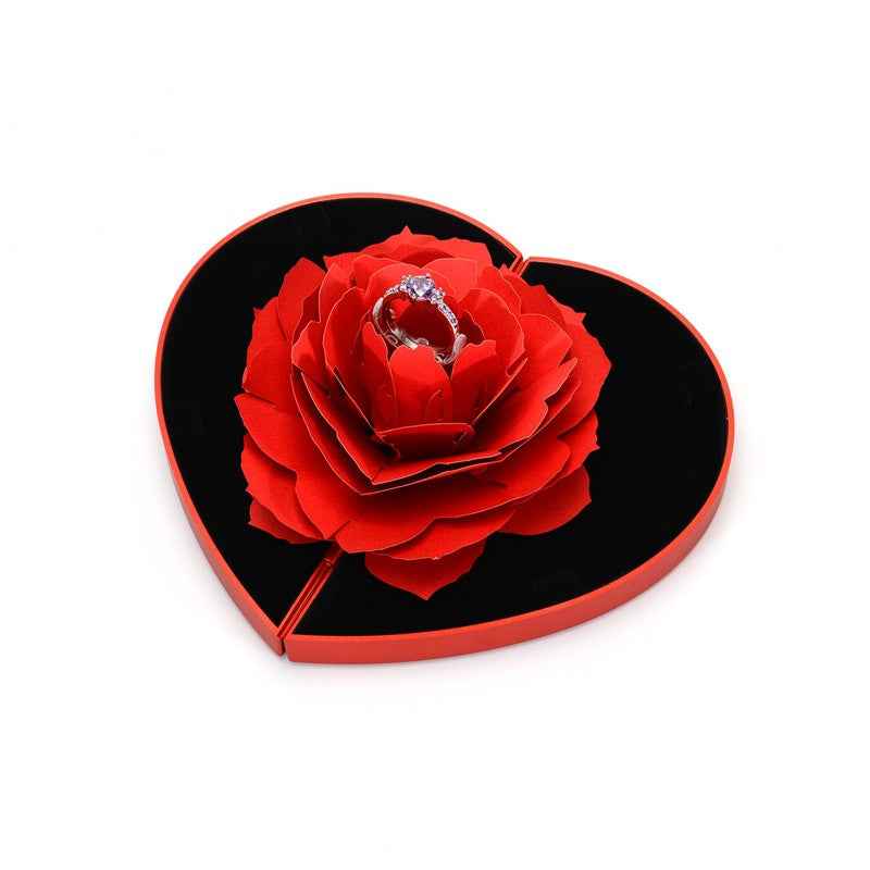 Heart-shaped red rose ring box with black insert and ring centerpiece