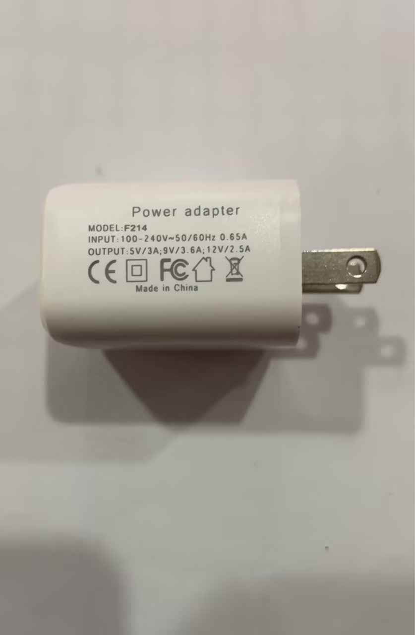 White power adapter with two-prong plug and printed labels