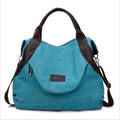 Lake blue canvas shoulder crossbody bag with dark brown handles and side zippers
