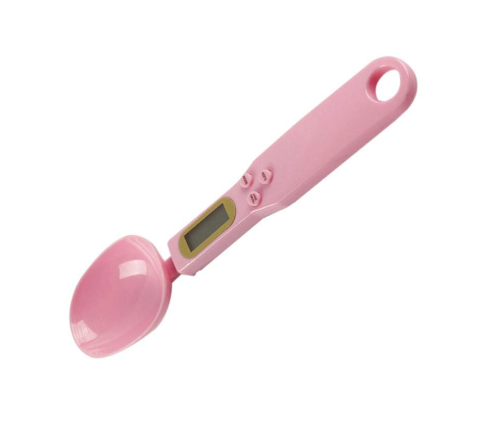 Pink measuring spoon scale with oval spoon bowl and small LCD display.