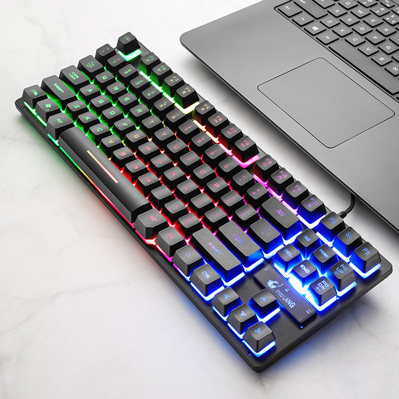 RGB mechanical keyboard on desk, angled view with green and blue lighting