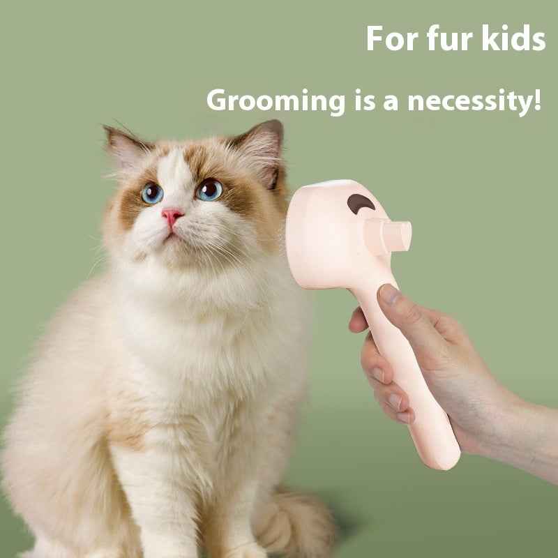 Pet hair grooming brush comb with white-and-pink head, held near a cream cat
