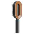 Self-cleaning hair brush with orange oval head and black pin bristles on dark handle