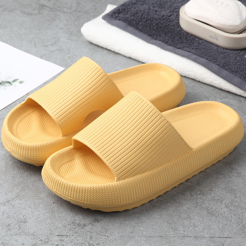 Yellow slide slippers with textured strap and cushioned sole