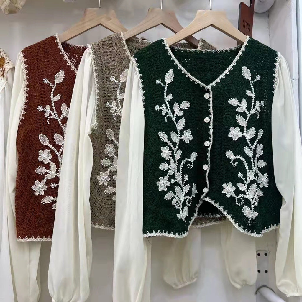 Embroidered V-neck sleeveless tops in maroon, taupe and dark green, hanging display