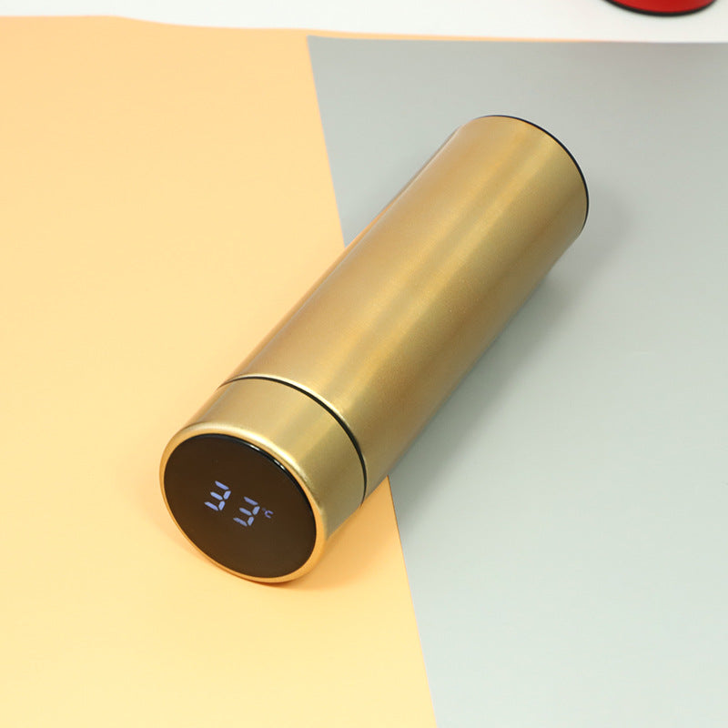Champagne gold insulated vacuum bottle with LED temperature display on dark end cap