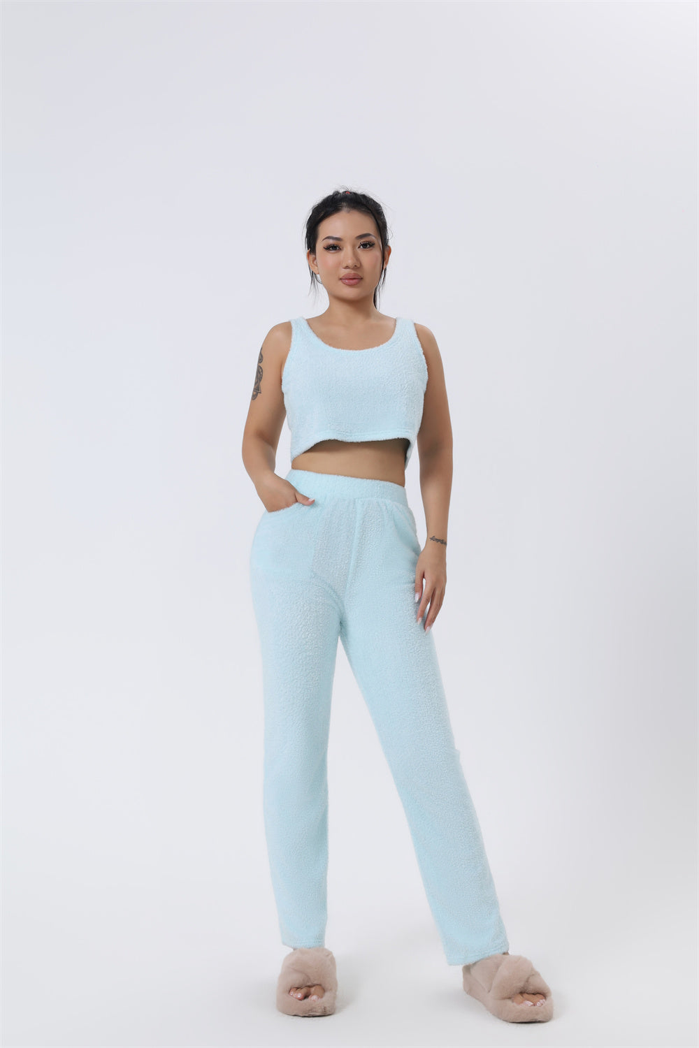 Women’s 3-piece lounge pajama set in light blue: sleeveless crop top and relaxed pants.