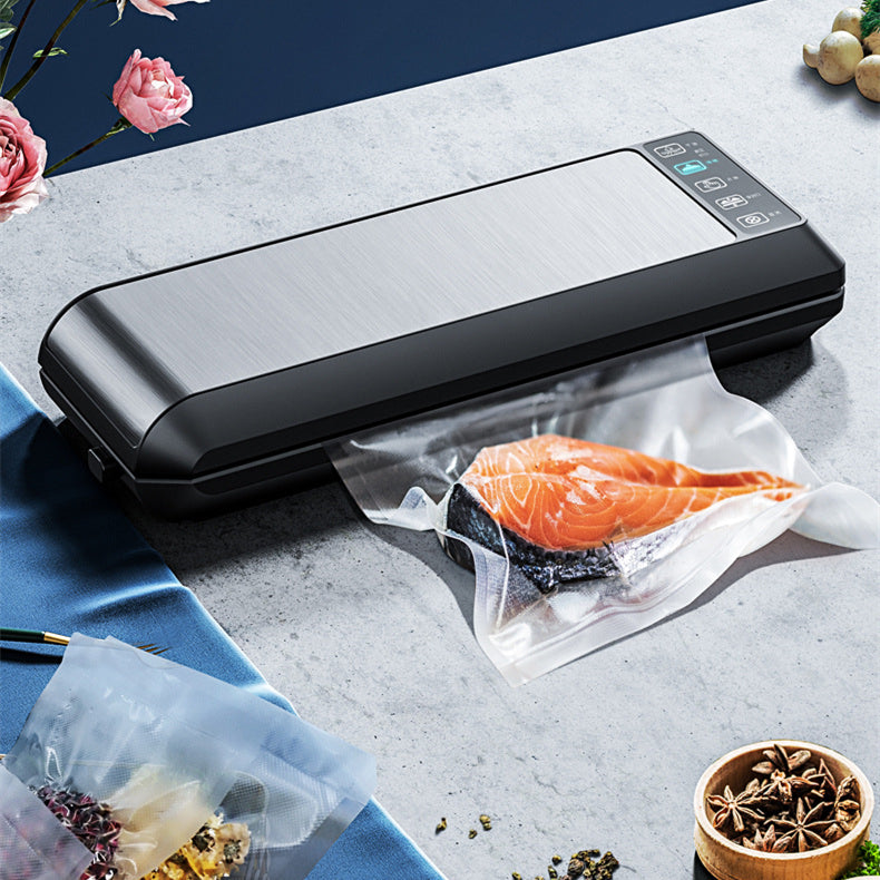 Black home vacuum sealer with sealed bag holding salmon fillet on counter