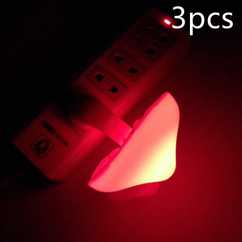 Mushroom night light wall plug lamp with red glowing mushroom head, close view