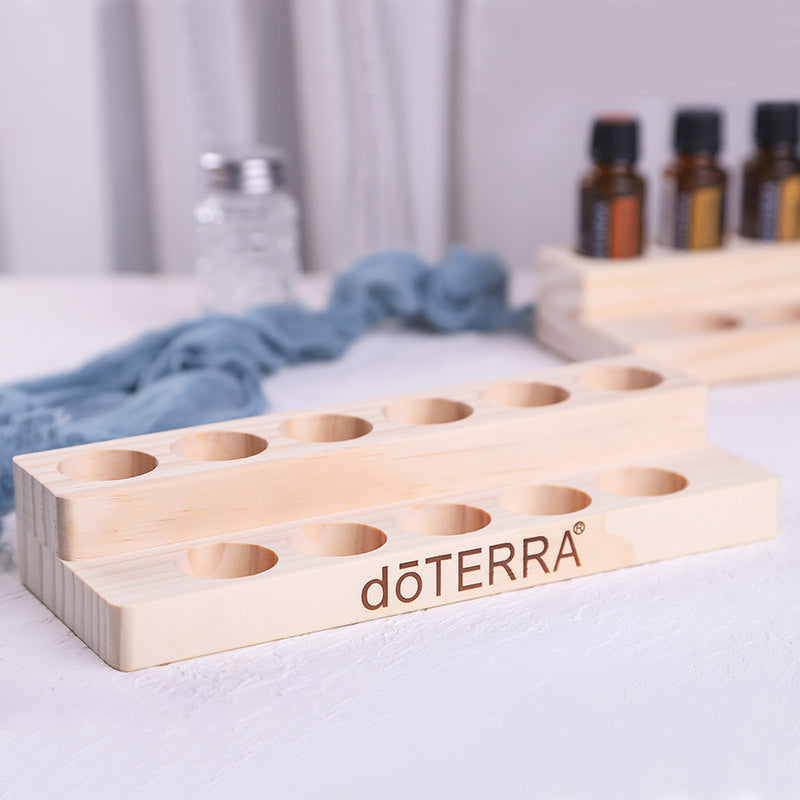 Essential oil display stand with 3-tier slots, light wood finish, dōTERRA logo