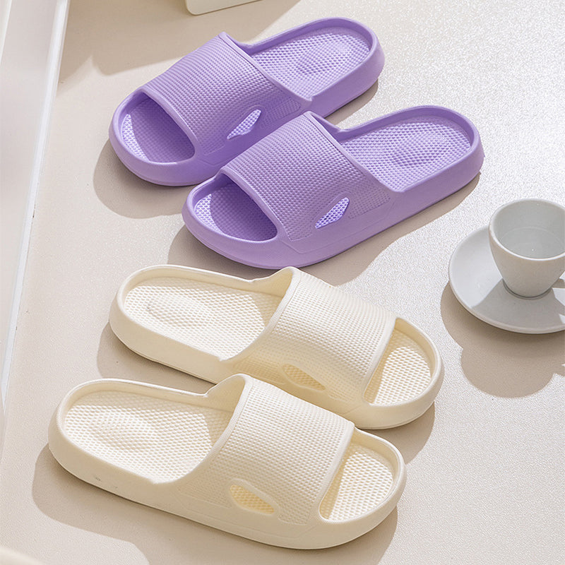 Purple and white thick-soled slide slippers with textured footbed