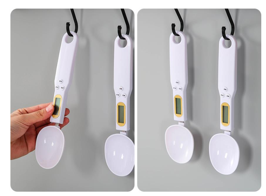 Pair of white measuring spoon scales with round spoons and small LCD screens.
