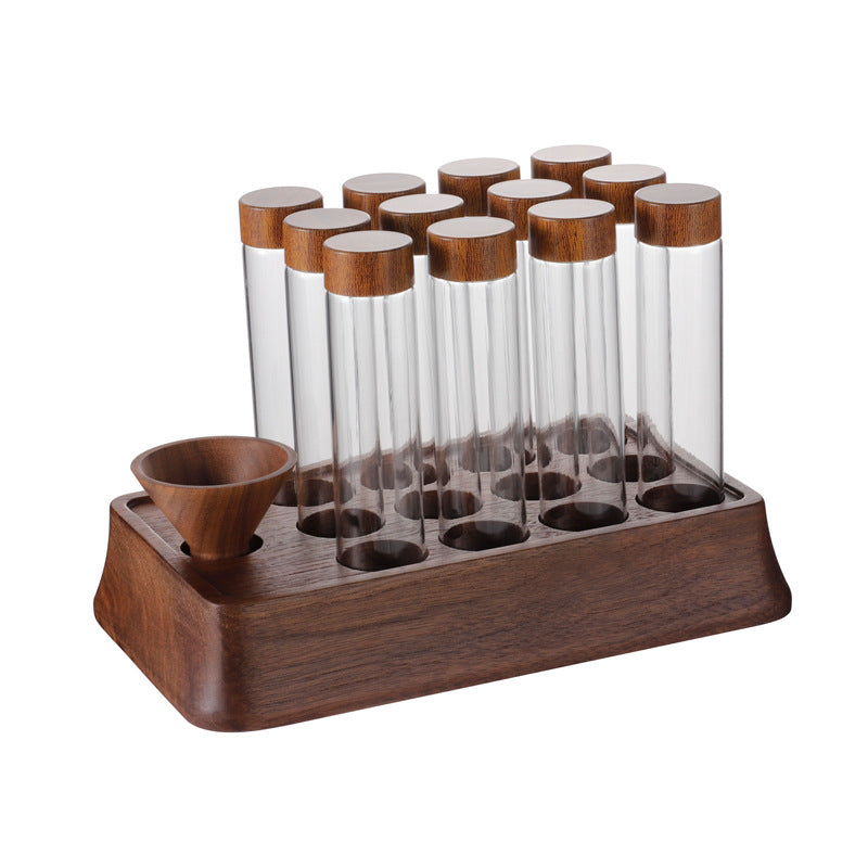 Wooden coffee bean display stand holding clear test tubes with cork lids and a wooden funnel cup