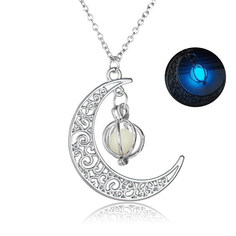 Silver crescent moon pendant necklace with glowing blue stone on a chain