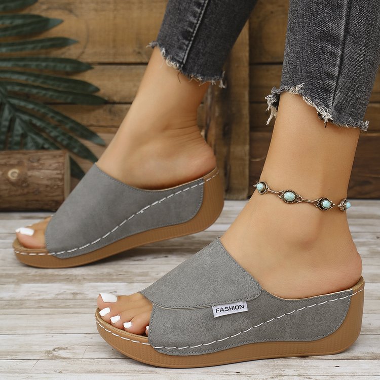 Women’s gray wedge slide sandals with open toe and thick sole, white contrast stitching