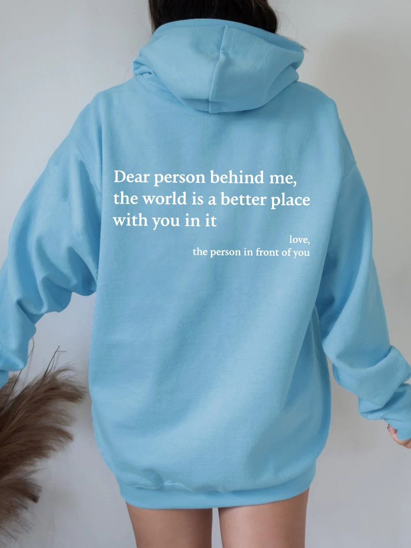 Light blue plush hoodie with hood, drawstrings, kangaroo pocket, and printed back message