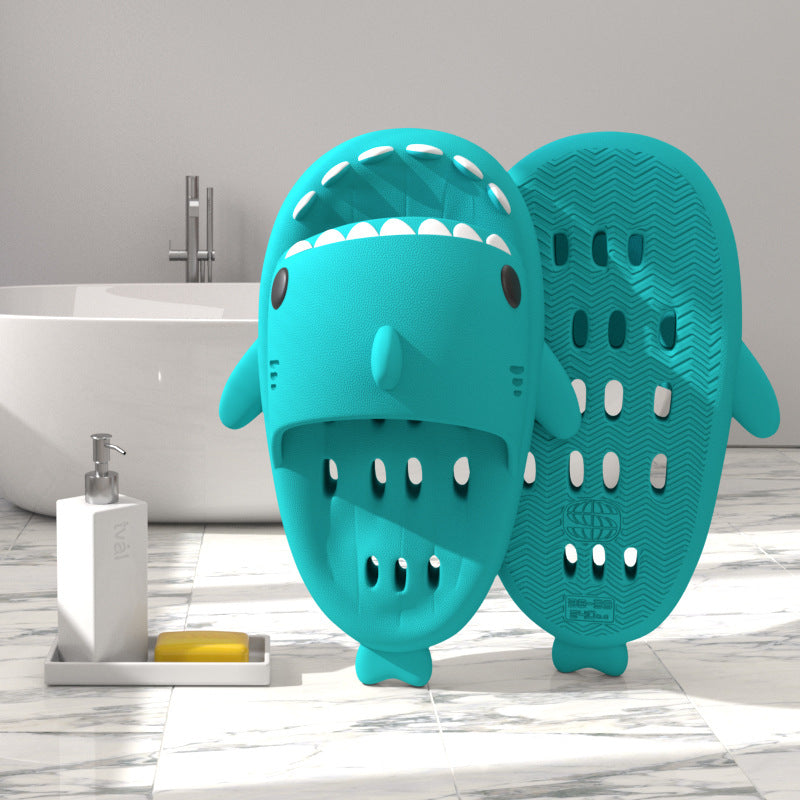 Teal shark-shaped EVA shower slide with drainage holes and textured sole