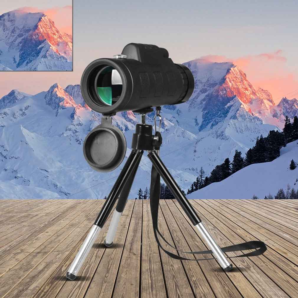 Zoom monocular telescope with tripod and side lens cap, black scope on stand
