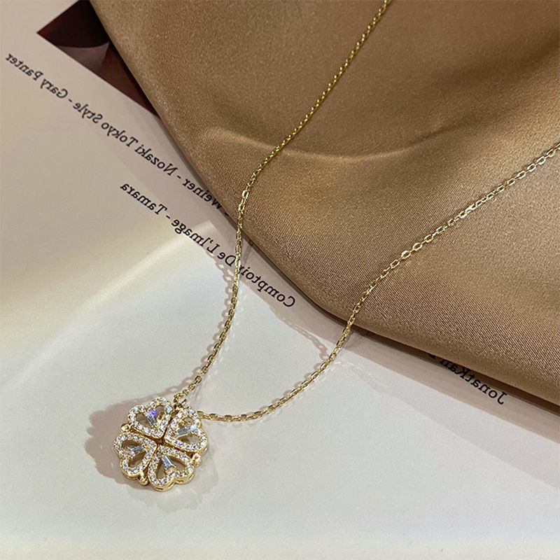Gold-tone openwork four-leaf clover pendant necklace with layered chain sparkle