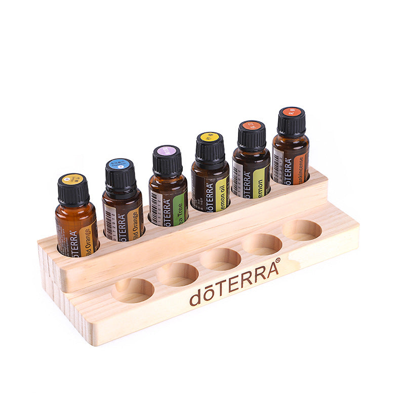 Essential oil display stand with row of bottle slots, light wood, dōTERRA branding