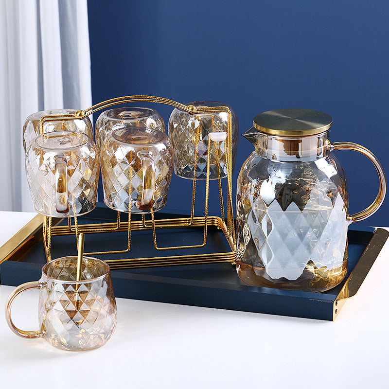 Set of glass cold water bottle and two matching cups, gold-tone caps and diamond pattern