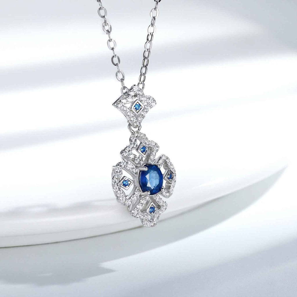 Silver necklace with blue sapphire pendant and small blue stones