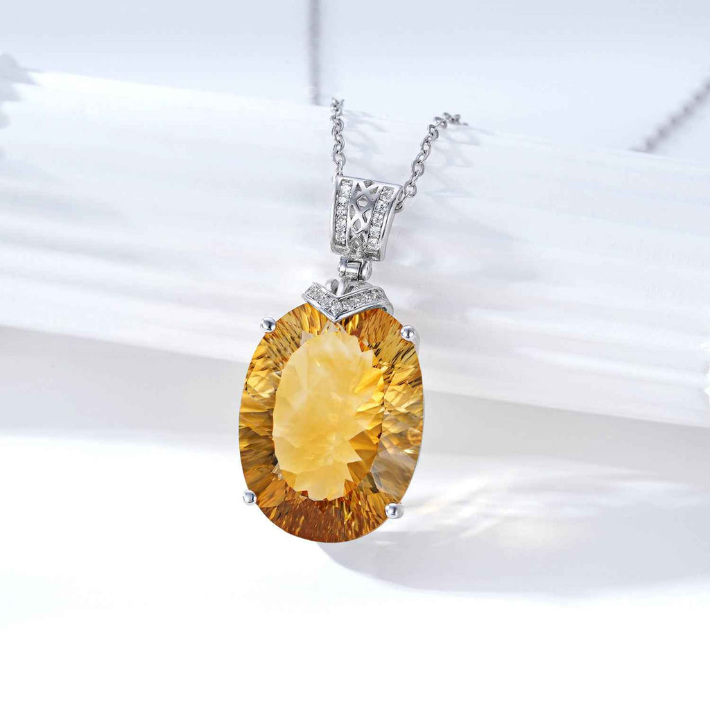 Silver necklace with yellow oval gemstone pendant and top crystal setting