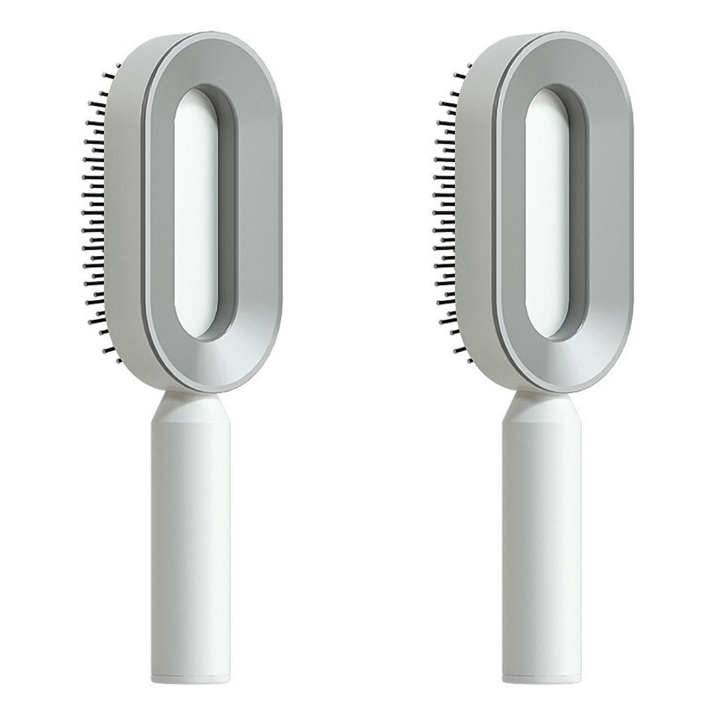 Set of self-cleaning hair brushes with white handles and gray oval heads
