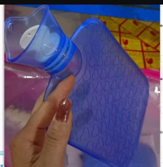 Blue hot water bottle with textured surface and neck stopper, close-up