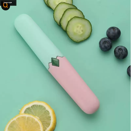 Two-in-one fruit knife with white handle and pink sleeve, green blade insert, angled view